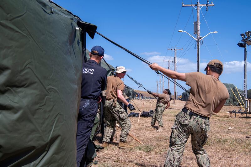 U.S. Navy sailors and Coast Guardsmen erect expeditionary shelter tents on February 2, 2025, ahead of the Trump administration's planned expansion of migrant detention at Guantanamo Bay.