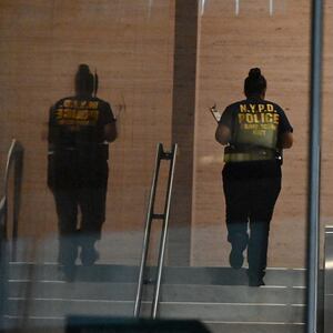 Members of the New York City Police Department Crime Scene Unit work at the scene and enter the building with evidence bags to collect evidence where five people were shot with four people including NYPD police officer Didarul Islam killed in a mass shooting attack at 345 Park Avenue by suspect Shane Tamura armed with an assault rifle in New York City, United States on July 28, 2025.
