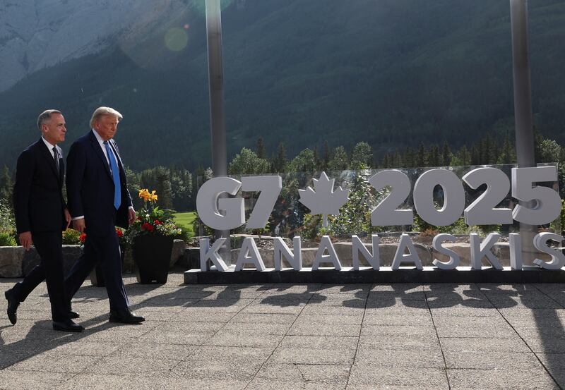 Canada's Prime Minister Mark Carney and U.S. President Donald Trump leave after a family photo session during the G7 Summit.