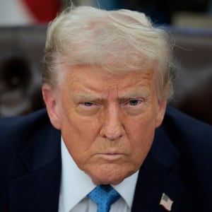 Donald Trump talks to reporters after signing an executive order.