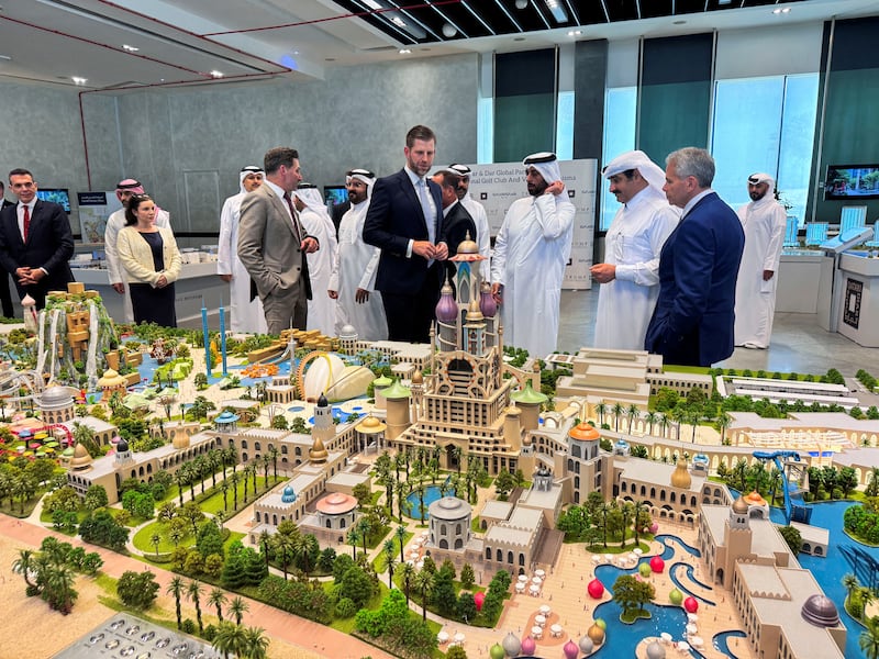 Eric Trump, Executive Vice President of the Trump Organization and son of U.S. President Donald Trump looks at the 3D model of Trump International Golf Club & Trump Villas project with Qatari Minister of Municipality & Chairman of Qatar Diar Abdullah Al Attiya, launched between Qatar Diar and DarGlobal in Doha, Qatar, April 30, 2025.