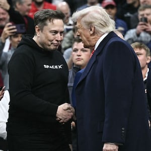 Tesla and SPaceX CEO Elon Musk and US President Donald Trump shake hands as they attend the men's NCAA wrestling competition at the Wells Fargo Center in Philadelphia, Pennsylvania, on March 22, 2025. (Photo by Brendan SMIALOWSKI / AFP) (Photo by BRENDAN SMIALOWSKI/AFP via Getty Images)