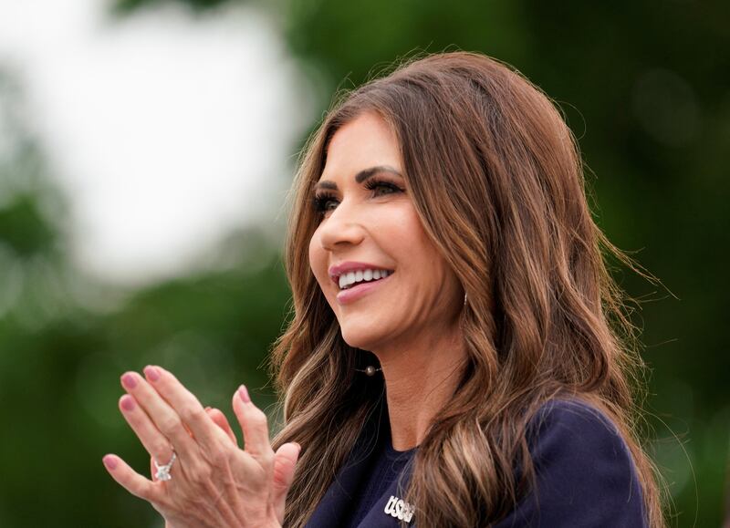 Homeland Security Secretary Kristi Noem applauds after addressing the graduating class at the Coast Guard Academy in New London, Connecticut.