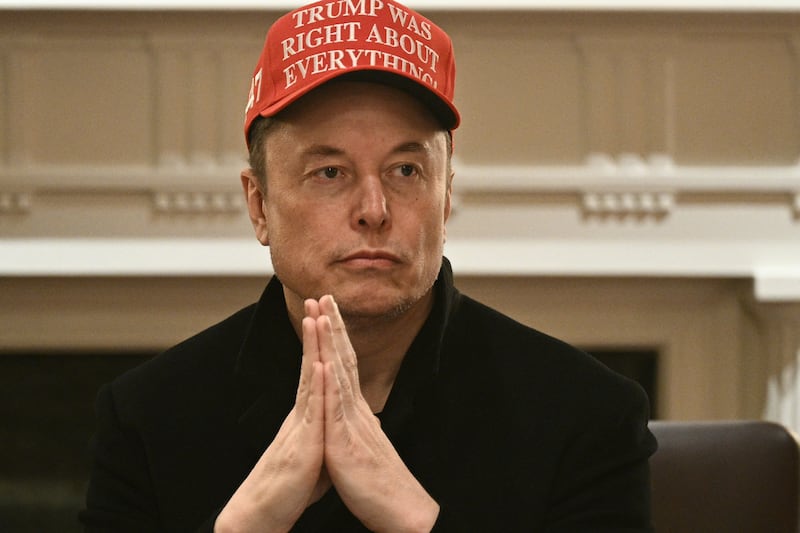 Elon Musk puts his hands together.