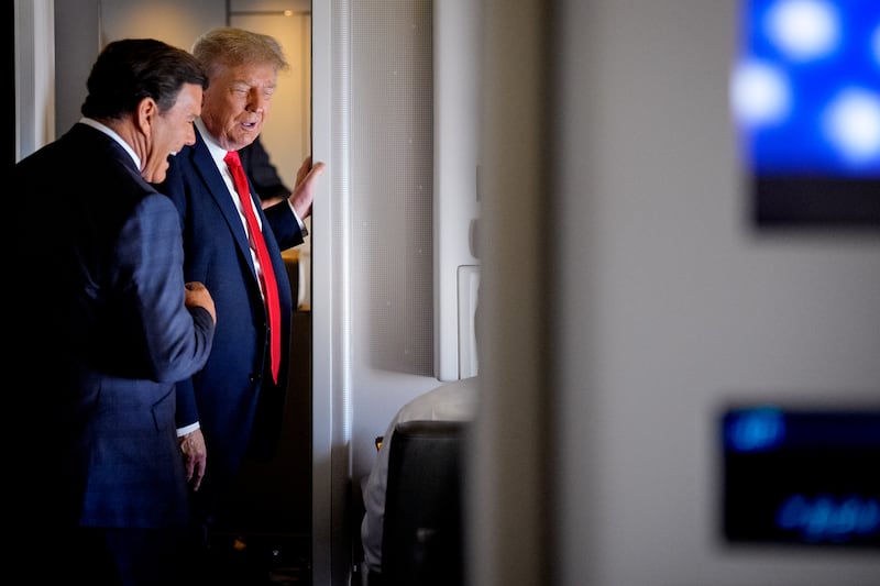 IN FLIGHT - AUGUST 15: U.S. President Donald Trump speak with FOX News journalist Bret Baier (L) aboard Air Force One on August 15, 2025, in flight. President Trump is traveling to Anchorage, Alaska, for peace talks with Russian President Vladimir Putin on the war with Ukraine.