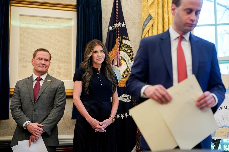 U.S. Department of Homeland Security Kristi Noem and U.S. National Security Advisor Mike Waltz  stand near a copy of the Declaration of Independence, as U.S. President Donald Trump (not pictured) signs executive orders and proclamations, in the Oval Office at the White House in Washington, D.C., U.S., April 9, 2025. REUTERS/Nathan Howard