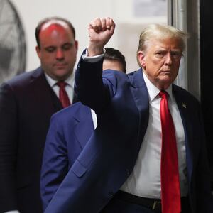 Former U.S. President Donald Trump gestures as he returns to court followed by his advisor Boris Epshteyn at Manhattan Criminal Court on May 16, 2024 in New York City.