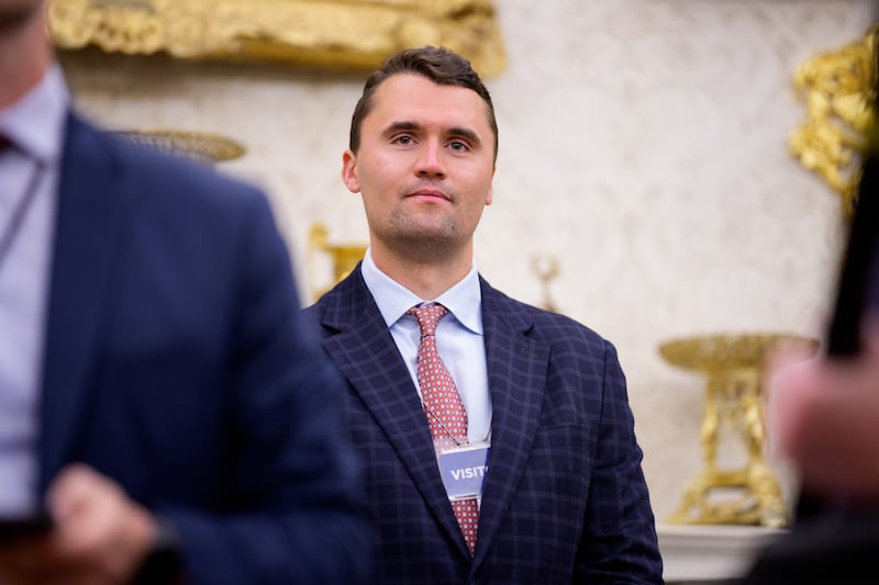WASHINGTON, DC - MAY 28: Turning Point USA co-founder Charlie Kirk stands in the back of the room as U.S. President Donald Trump speaks during a swearing in ceremony for interim U.S. Attorney for Washington, D.C. Jeanine Pirro in the Oval Office of the White House on May 28, 2025 in Washington, DC. Trump has announced Pirro, a former Fox News personality, judge, prosecutor, and politician, after losing support in the Senate for his first choice, Ed Martin, over his views on the January 6, 2021 attack on the U.S. Capitol. (Photo by Andrew Harnik/Getty Images)