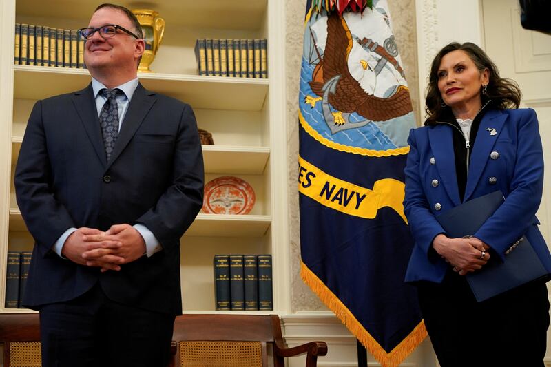 Michigan Governor Gretchen Whitmer stands next to Michigan House Speaker Matt Hall, as U.S. President Donald Trump (not pictured) signs executive orders and proclamations, in the Oval Office at the White House in Washington, D.C., U.S., April 9, 2025. REUTERS/Nathan Howard