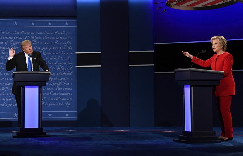 TOPSHOT - Republican nominee Donald Trump (L) looks on as Democratic nominee Hillary Clinton speaks during the first presidential debate at Hofstra University in Hempstead, New York on September 26, 2016. (Photo by Jewel SAMAD / AFP) (Photo by JEWEL SAMAD/AFP via Getty Images)