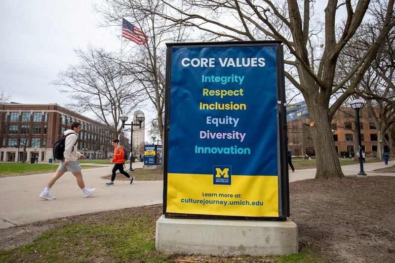 ANN ARBOR, MICHIGAN - APRIL 3: University of Michigan students walk on the UM campus next to signage displaying the University's "Core Values" on April 3, 2025 in  Ann Arbor, Michigan. Last week, the University stated it was closing its Office of Diversity, Equity and Inclusion, Office of Healthy Equity and Inclusion, and its DEI 2.0 Strategic Plan, all in response to President Donald Trump's Executive Orders concerning DEI. (Photo by Bill Pugliano/Getty Images)