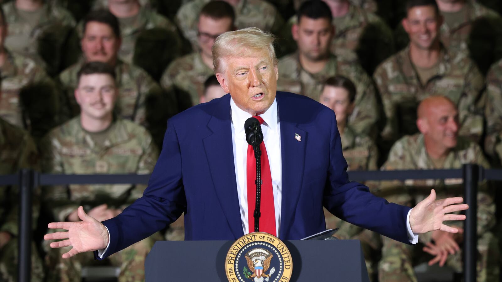 President Trump speaks while Michigan Air National Guard troops stand behind him.