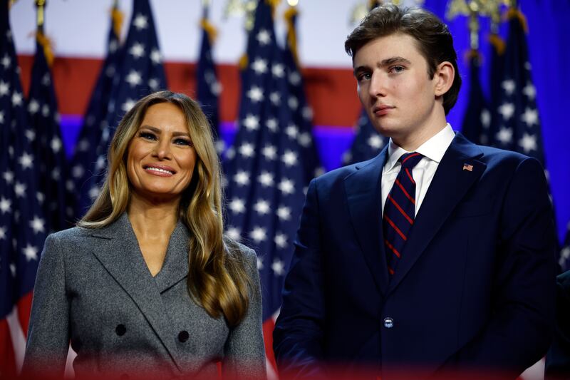 WEST PALM BEACH, FLORIDA - NOVEMBER 06: Former first lady Melania Trump and Barron Trump look on as Republican presidential nominee, former U.S. President Donald Trump speaks during an election night event at the Palm Beach Convention Center on November 06, 2024 in West Palm Beach, Florida. Americans cast their ballots today in the presidential race between Republican nominee former President Donald Trump and Vice President Kamala Harris, as well as multiple state elections that will determine the balance of power in Congress.   (Photo by Chip Somodevilla/Getty Images)