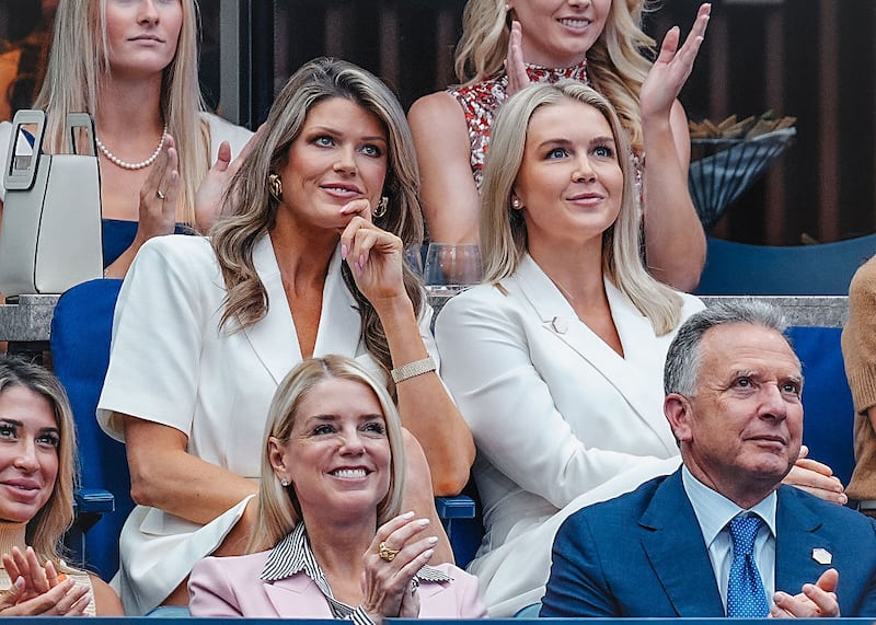 Lindsey Halligan (L) and Karoline Leavitt (C) attend the Men's Singles Final on Day 15 of the 2025 US Open Tennis Championships at the USTA Billie Jean King National Tennis Center on September 07, 2025 in Flushing Meadows, Queens, New York City.  (Photo by XNY/Star Max/GC Images)