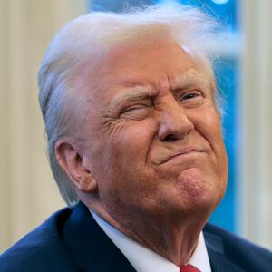 President Donald Trump reacts to a reporter's question from the Resolute Desk after signing an executive order to appoint the deputy administrator of the Federal Aviation Administration in the Oval Office at the White House on January 30, 2025 in Washington, DC. Trump also signed a memorandum ordering an immediate assessment of aviation safety and ordering an elevation of what he called “competence” over “D.E.I."