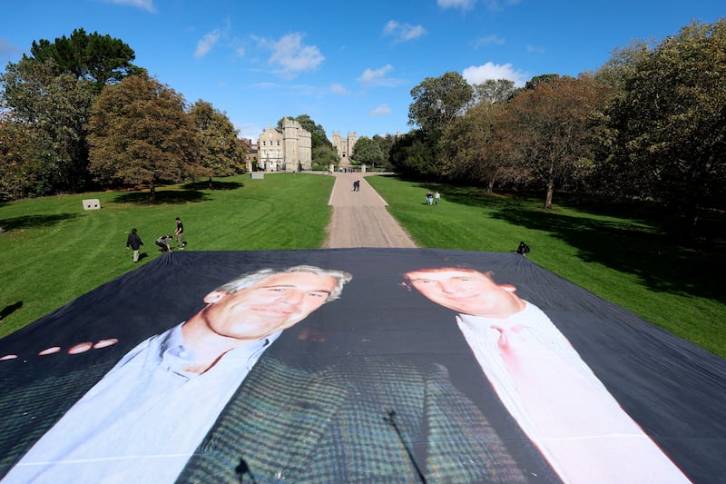 A large banner depicting U.S. President Donald Trump alongside disgraced financier Jeffrey Epstein is displayed near the Windsor Castle by campaign group 'Everyone Hates Elon', protesting Trump's state visit to the country, in Windsor, Britain, September 15, 2025. REUTERS/Hannah McKay REFILE - CORRECTING NAME OF CAMPAIGN GROUP FROM "EVERYBODY HATES ELON" TO "EVERYONE HATES ELON".     TPX IMAGES OF THE DAY