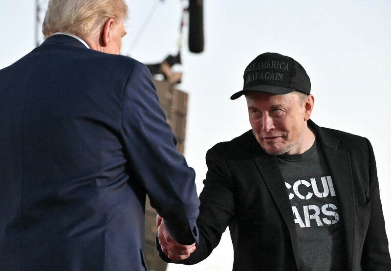 Elon Musk (R) joins Donald Trump during a campaign rally at site of his first assassination attempt in Butler, Pennsylvania on October 5, 2024.