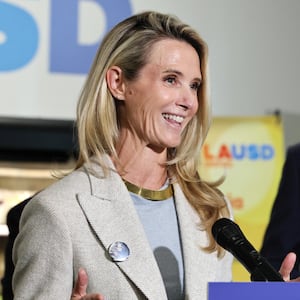 California Governor Gavin Newsom looks on as his wife Jennifer Siebel Newsom speaks at Belvedere Middle School before he signed legislation aimed at improving kids' nutrition and health across California on October 8, 2025 in Los Angeles, California.