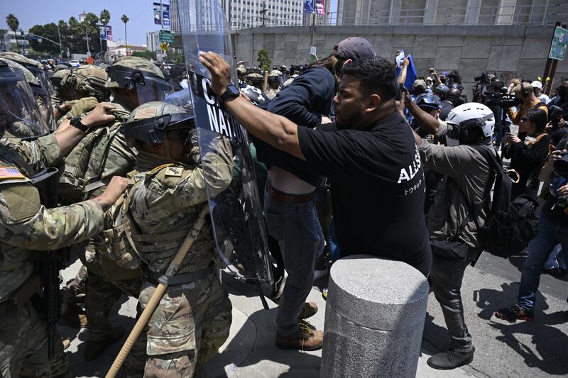 National guards confront with protesters outside of the Metropolitan Detention Center in Los Angeles.