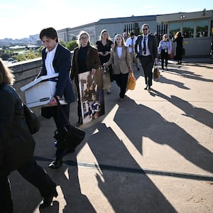 Reporters carry their belongings from the Pentagon in Washington, DC, on October 15, 2025 after US and international news outlets including The New York Times, AP, AFP and Fox News declined to sign new restrictive Pentagon media rules, and were stripped of their press access credentials. The new rules come after the Defense Department restricted media access inside the Pentagon, forced some outlets to vacate offices in the building and drastically reduced the number of briefings for journalists. (Photo by Brendan SMIALOWSKI / AFP) (Photo by BRENDAN SMIALOWSKI/AFP via Getty Images)