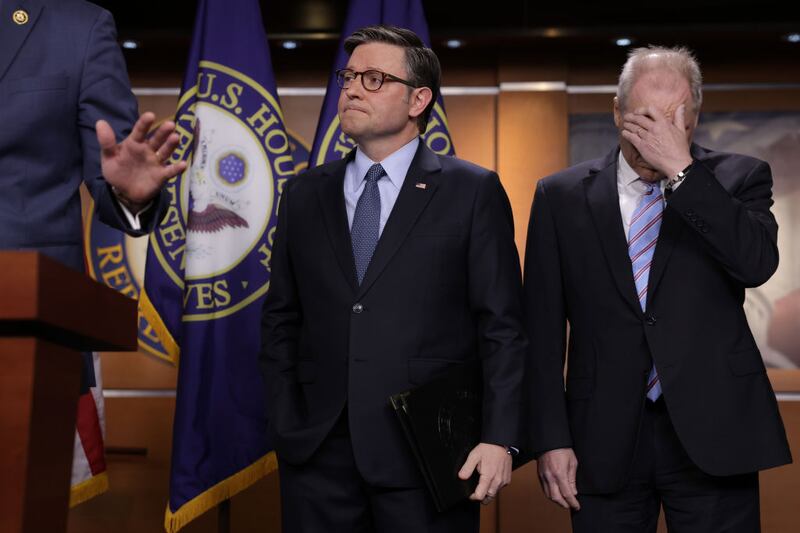 Speaker of the House Mike Johnson and House Majority Leader Steve Scalise listen during a news conference at the U.S. Capitol.