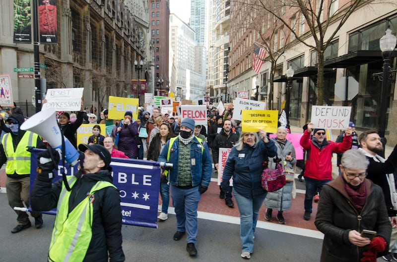Protesters gather by Gold Coast Tesla dealership in Chicago on Saturday.