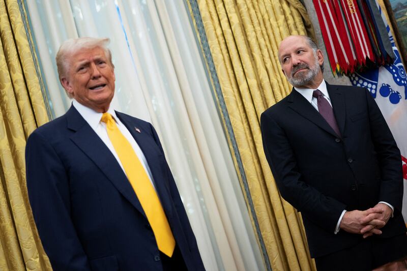 U.S. President Donald Trump speaks alongside Howard Lutnick in the Oval Office of the White House on the day Lutnick is sworn in as U.S. Commerce Secretary by U.S. Vice President JD Vance, in Washington, D.C., U.S., February 21, 2025.