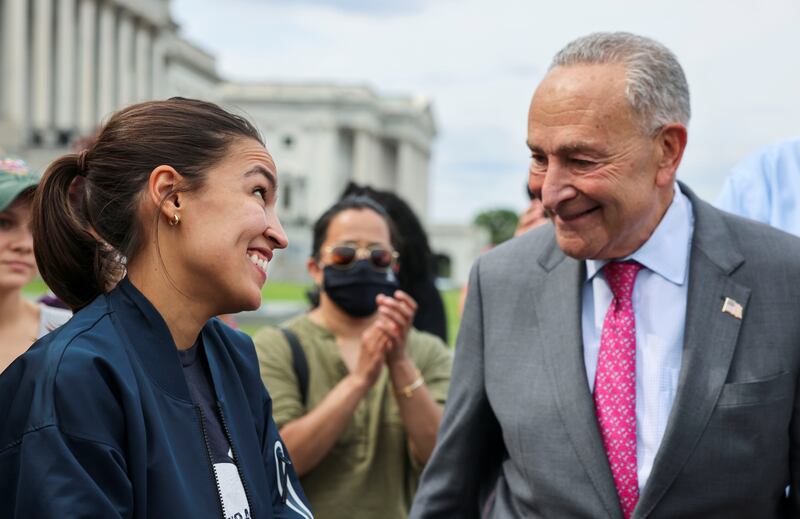 Rep. Alexandria Ocasio-Cortez chats with Sen. Chuck Schumer in 2021. Some Democratic lawmakers are now hoping Ocasio-Cortez can best Schumer in a Senate primary in 2028.