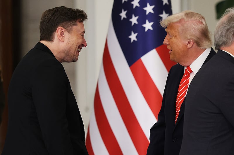 DOHA, QATAR - MAY 14: U.S. President Donald J. Trump greets Tesla CEO Elon Musk before a state dinner at the Lusail Palace on May 14, 2025, in Doha, Qatar. The visit underscores the strategic partnership between the United States and Qatar, focusing on regional security and economic collaboration.  (Photo by Win McNamee/Getty Images)