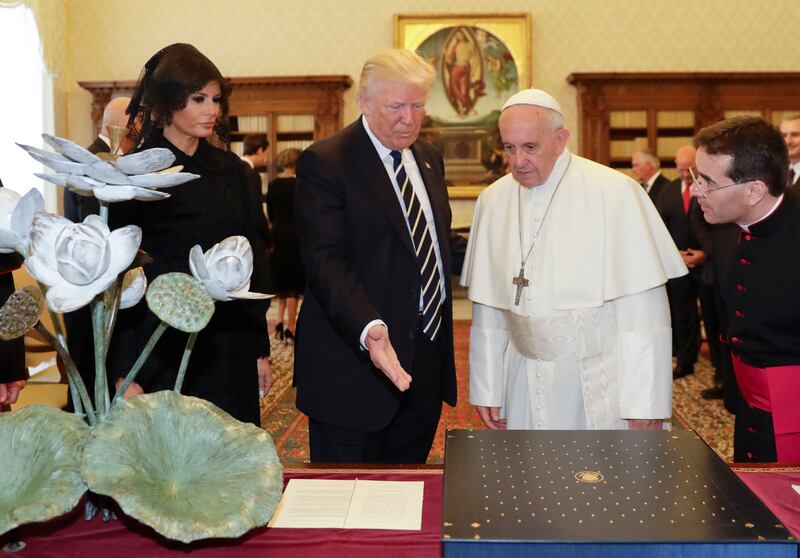 Pope Francis exchanges gifts with President Donald Trump and First Lady Melania Trump during a private audience at the Vatican on May 24, 2017.
