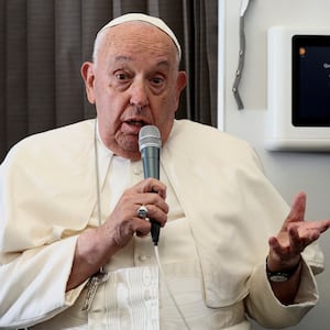 Pope Francis delivering a press conference aboard the papal plane.
