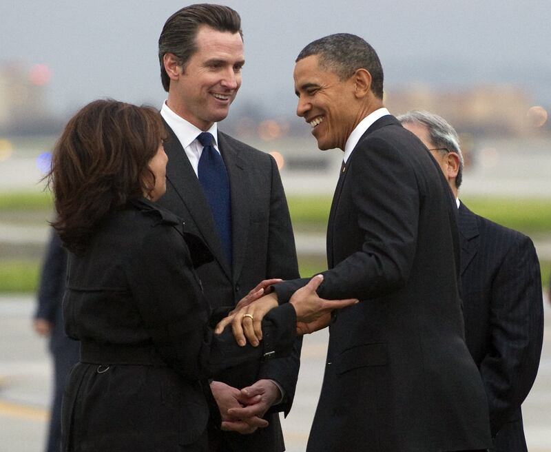 US President Barack Obama greets California Attorney General Kamala Harris (L) and Gavin Newsom, Lieutenant Governor of California, after arriving on Air Force One at San Francisco International Airport in San Francisco, California, February 17, 2011. Obama is traveling on a two-day trip to the West Coast, where he will meet with technology business leaders in California and tour an Intel plant in Oregon. AFP PHOTO / Saul LOEB (Photo credit should read SAUL LOEB/AFP via Getty Images)
