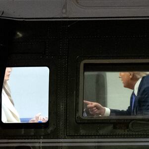 US President Donald Trump speaks with First Lady Melania Trump onboard Marine One