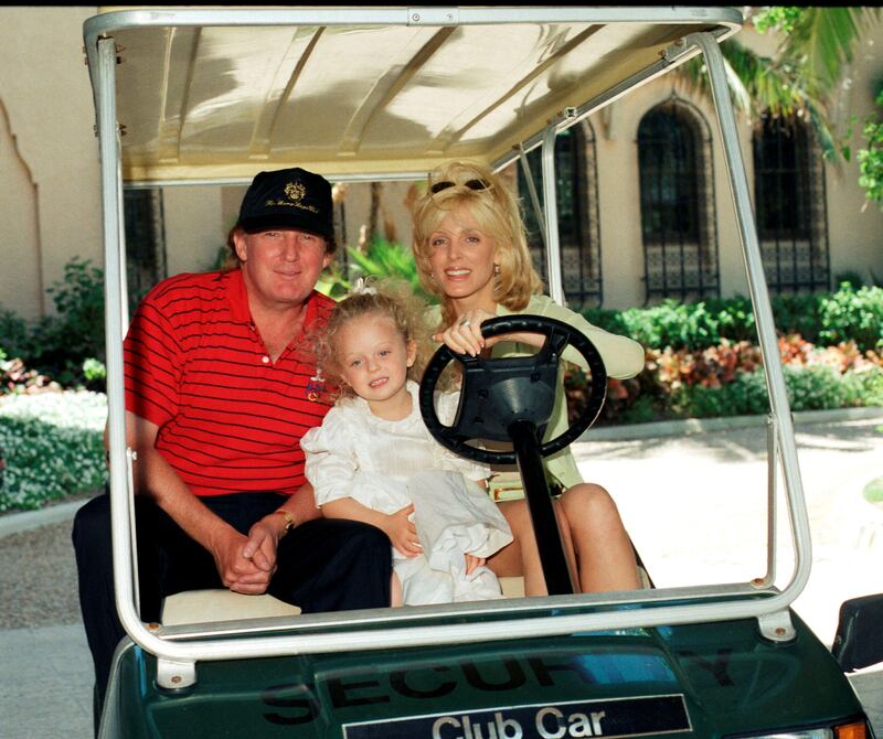 Donald Trump and Marla Maples smile alongside their daughter, Tiffany, at Mar-a-Lago in 1998.
