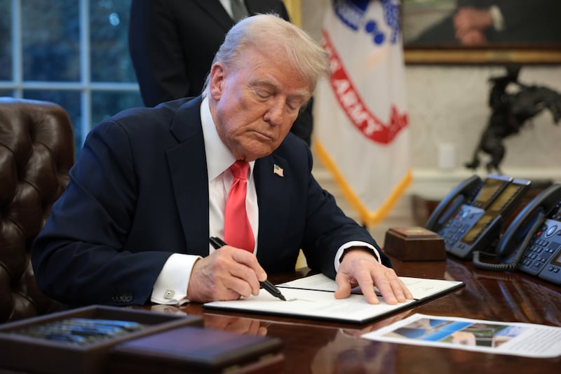 President Donald Trump signs an executive order in the Oval Office at the White House on February 25, 2025 in Washington, DC.