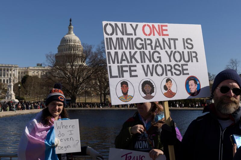 Protesters hold signs during ''Not My President's Day'' protests at the Capitol in Washington, D.C. on February 17, 2025.