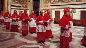 The procession of the Sacred College of Cardinals file into the Sistine Chapel