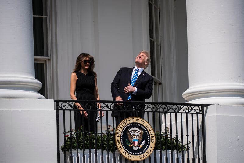 President Donald Trump looks up toward the solar eclipse—without protective glasses—from a balcony at the White House in Washington, D.C. on August 21, 2017.