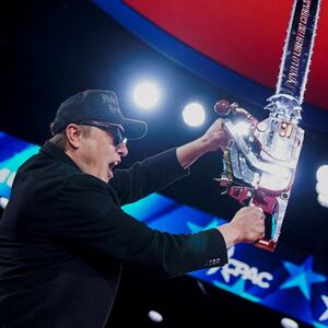 Elon Musk holds up a chainsaw onstage during the Conservative Political Action Conference (CPAC) in National Harbor, Maryland, U.S., February 20, 2025.
