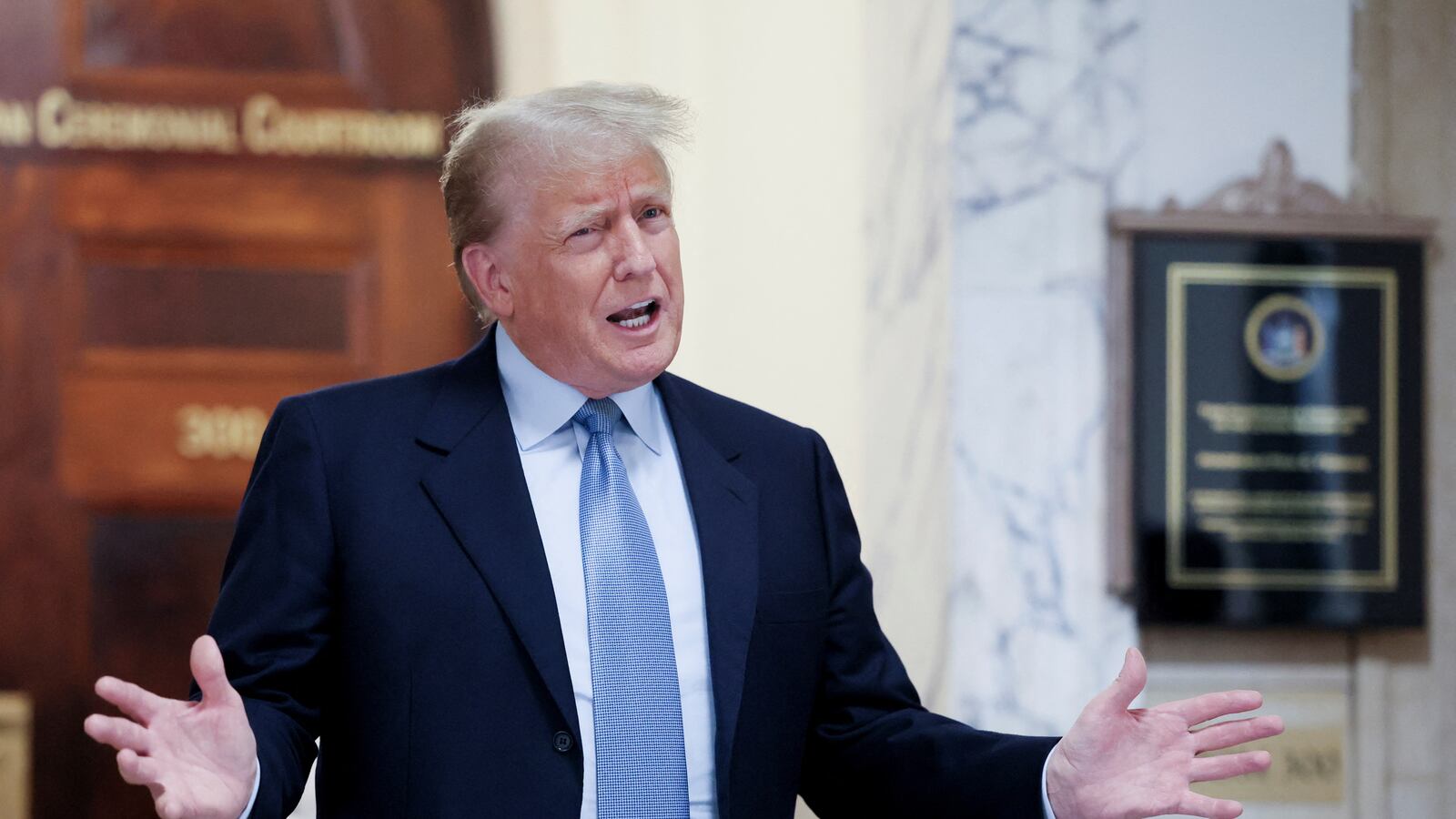 Former U.S. President Donald Trump delivers remarks after exiting the courtroom as he attends his Manhattan courthouse trial in a civil fraud case in New York