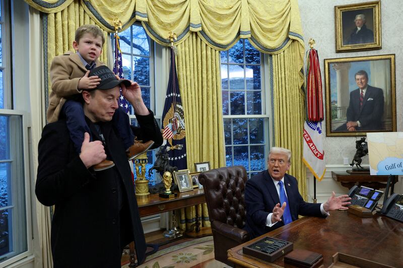 President Donald Trump speaks as Elon Musk carries his son X Æ A-12 on his shoulders in the Oval Office of the White House in Washington, D.C. on February 11, 2025.