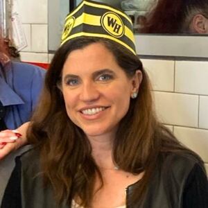 Nancy Mace wearing a Waffle House paper cap.