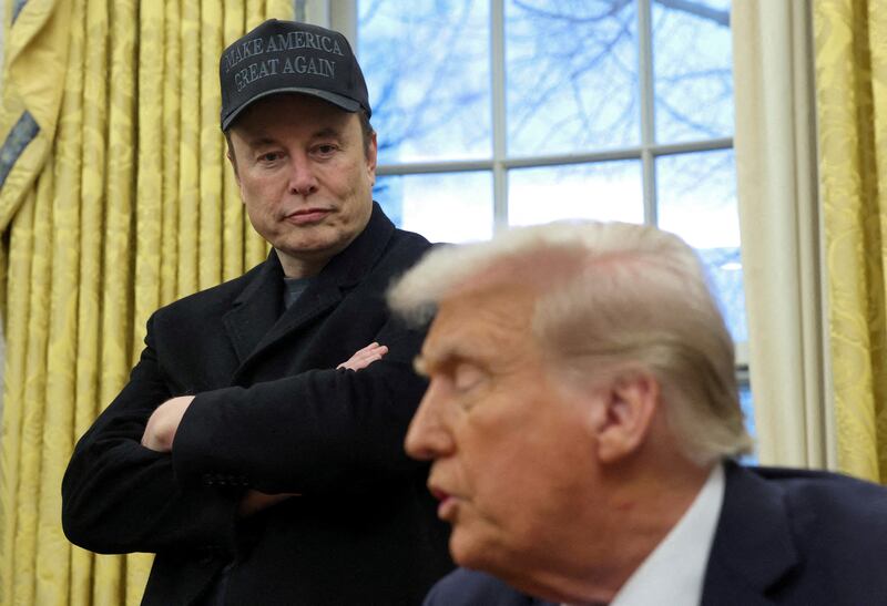 Elon Musk listens as President Donald Trump speak in the White House Oval Office in Washington, D.C., on February 11, 2025.
