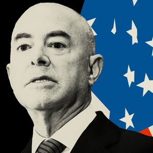 Photo illustration of Alejandro Mayorkas on a black background and with an American flag behind him