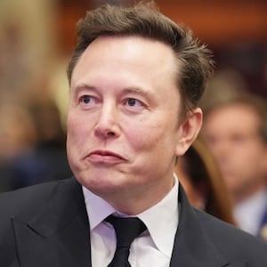 Elon Musk listens as U.S. President-elect Donald Trump addresses a House Republicans Conference meeting at the Hyatt Regency on Capitol Hill on November 13, 2024 in Washington, DC.