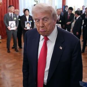 U.S. President Donald Trump (L) reacts to a reporter's question after taking a picture with Japanese Prime Minister Sanae Takaichi and family members of Japanese citizens who North Korea has abducted during a meeting at Akasaka Palace on October 28, 2025 in Tokyo, Japan.