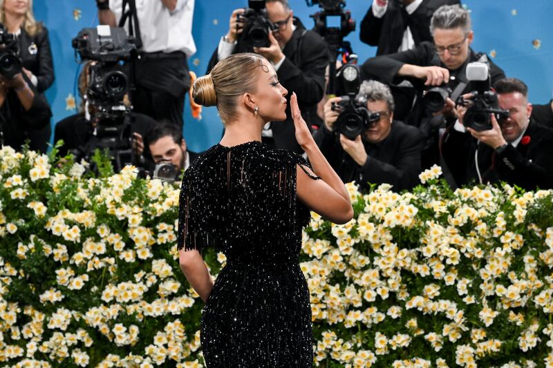 Sydney Sweeney blows a kiss to photographers on the red carpet at the 2025 Met Gala on May 5, 2025 in New York City.